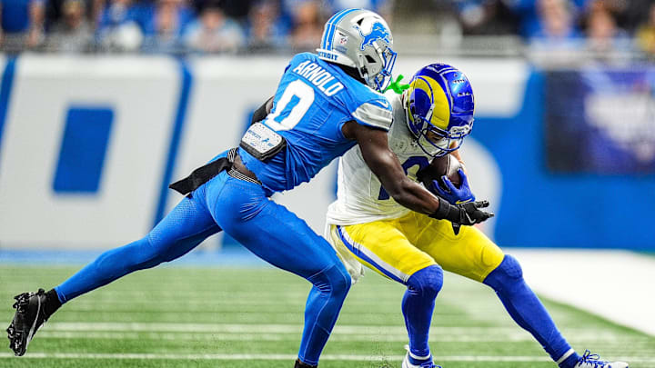 Detroit Lions cornerback Terrion Arnold (0) tackles Los Angeles Rams wide receiver Cooper Kupp (10) 
