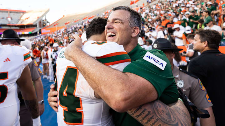 Aug 31, 2024; Gainesville, Florida, USA; Miami Hurricanes head coach Mario Cristobal hugs tight end Cam McCormick (84) after a game against the Florida Gators at Ben Hill Griffin Stadium. Mandatory Credit: Matt Pendleton-Imagn Images