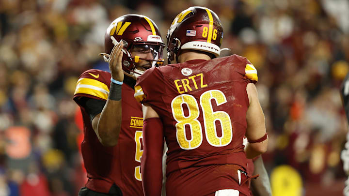 Dec 29, 2024; Landover, Maryland, USA; Washington Commanders quarterback Jayden Daniels (5) celebrates with Commanders tight end Zach Ertz (86) after connecting on a touchdown pass against the Atlanta Falcons during the third quarter at Northwest Stadium. Mandatory Credit: Geoff Burke-Imagn Images