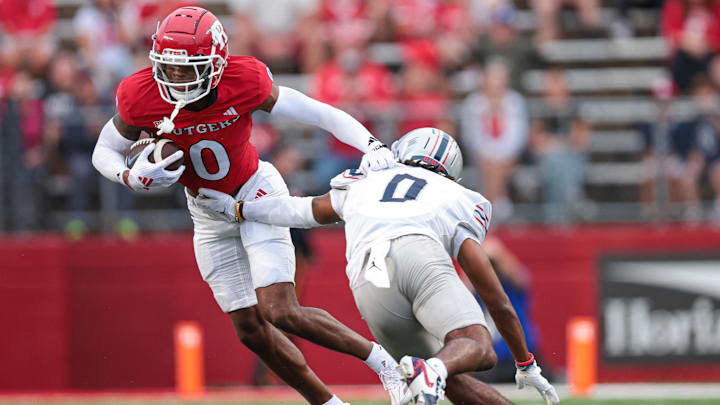 Aug 29, 2024; Piscataway, New Jersey, USA; Rutgers Scarlet Knights defensive back Eric Rogers (0) breaks a tackle by Howard Bison defensive back Kenny Gallop Jr. (0) after an interception during the first half at SHI Stadium. Mandatory Credit: Vincent Carchietta-Imagn Images