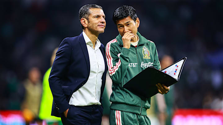Team Mexico coach Jaime Lozano and his top assistant Ryota Nishimura talk strategy during El Tri's Nations League quarterfinal match against Honduras.
