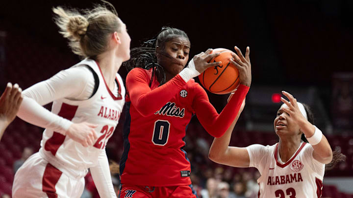 Feb 5, 2026; Tuscaloosa, AL, USA; Ole Miss guard Sira Thienou (0) grabs a rebound between Alabama guard Karly Weathers (22) and Alabama guard Jessica Timmons (23) at Coleman Coliseum. Mandatory Credit: Gary Cosby Jr.-Tuscaloosa News