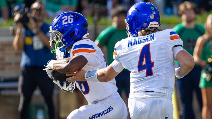 Boise State quarterback Maddux Madsen hands off to Sire Gaines. Boise State quarterback Maddux Madsen hands off to Sire Gaines.