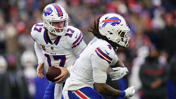 Dec 14, 2025; Foxborough, Massachusetts, USA; Buffalo Bills quarterback Josh Allen (17) fakes the hand off to running back James Cook III (4) against the New England Patriots in the second half at Gillette Stadium. Dec 14, 2025; Foxborough, Massachusetts, USA; Buffalo Bills quarterback Josh Allen (17) fakes the hand off to running back James Cook III (4) against the New England Patriots in the second half at Gillette Stadium.