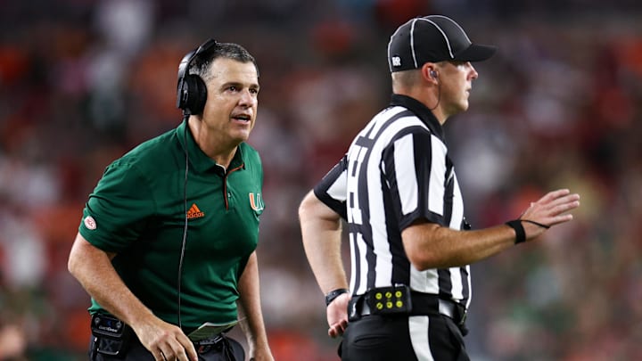 Sep 21, 2024; Tampa, Florida, USA; Miami Hurricanes head coach Mario Cristobal reacts to a play against the South Florida Bulls in the fourth quarter at Raymond James Stadium. Mandatory Credit: Nathan Ray Seebeck-Imagn Images Sep 21, 2024; Tampa, Florida, USA; Miami Hurricanes head coach Mario Cristobal reacts to a play against the South Florida Bulls in the fourth quarter at Raymond James Stadium. Mandatory Credit: Nathan Ray Seebeck-Imagn Images