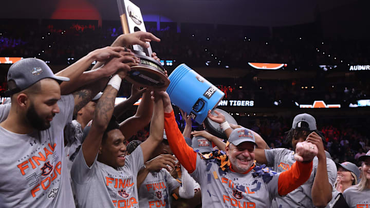 Mar 30, 2025; Atlanta, GA, USA; Auburn Tigers forward Johni Broome (4), left, guard Tahaad Pettiford (0) and head coach Bruce Pearl celebrate with teammates after winning the South Regional final of the 2025 NCAA tournament against the Michigan State Spartans at State Farm Arena. Mandatory Credit: Brett Davis-Imagn Images