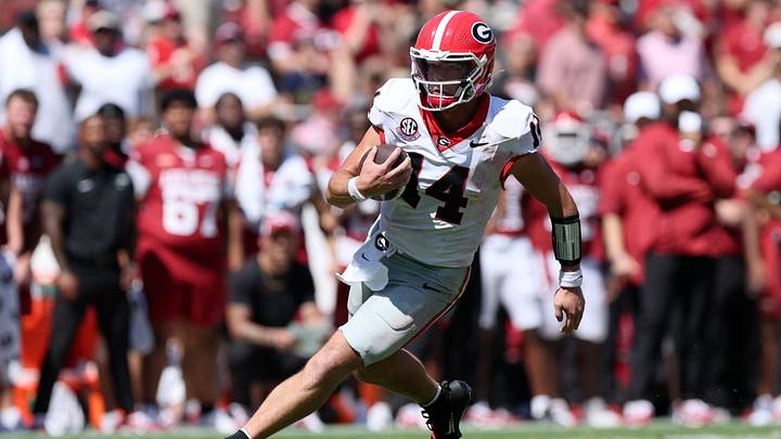 Sep 19, 2026; Fayetteville, Arkansas, USA;  Georgia Bulldogs quarterback Gunner Stockton (14) runs with the ball against the Arkansas Razorbacks during the second half at Donald W. Reynolds Razorback Stadium.  Mandatory Credit: Nelson Chenault-Imagn Images