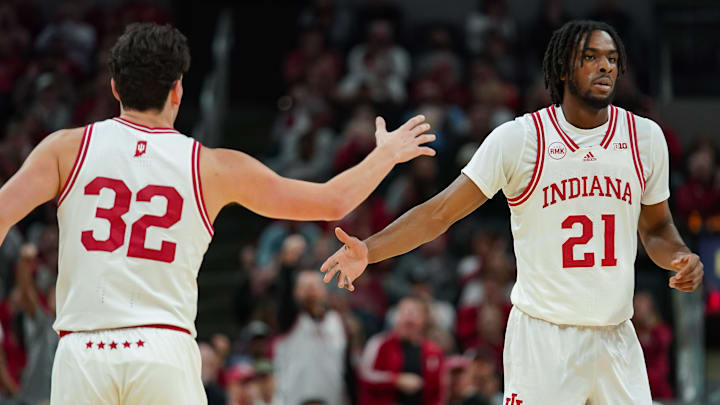 Indiana Hoosiers guard Trey Galloway (32) high-fives forward Mackenzie Mgbako (21) against Harvard at Gainbridge Fieldhouse.