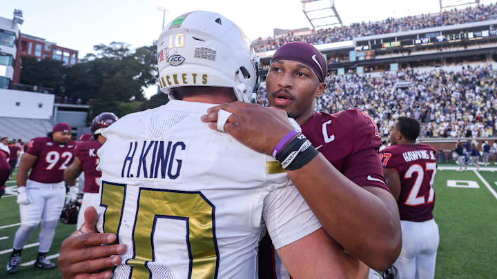 Oct 11, 2025; Atlanta, Georgia, USA; Georgia Tech Yellow Jackets quarterback Haynes King (10) talks to Virginia Tech Hokies quarterback Kyron Drones (1) after a game at Bobby Dodd Stadium at Hyundai Field. Mandatory Credit: Brett Davis-Imagn Images
Oct 11, 2025; Atlanta, Georgia, USA; Georgia Tech Yellow Jackets quarterback Haynes King (10) talks to Virginia Tech Hokies quarterback Kyron Drones (1) after a game at Bobby Dodd Stadium at Hyundai Field. Mandatory Credit: Brett Davis-Imagn Images