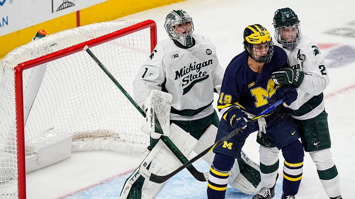 Michigan State goaltender Trey Augustine (1), left, tends net against Michigan forward Michael Hage (19) during the second period of Duel in the D at Little Caesars Arena in Detroit on Saturday, February 7, 2026. Michigan State goaltender Trey Augustine (1), left, tends net against Michigan forward Michael Hage (19) during the second period of Duel in the D at Little Caesars Arena in Detroit on Saturday, February 7, 2026.