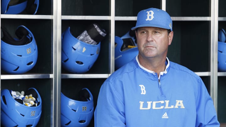 Jun 24, 2013; Omaha, NE, USA; UCLA Bruins head coach John Savage (22) looks on in the dugout before game 1 of the College World Series finals against the Mississippi State Bulldogs at TD Ameritrade Park. Mandatory Credit: Bruce Thorson-Imagn Images