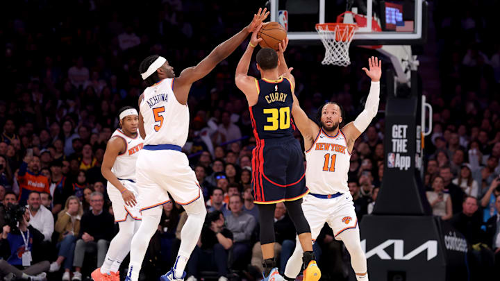 New York Knicks forward Precious Achiuwa (5) blocks a three point shot by Golden State Warriors guard Stephen Curry (30) in front of Knicks guard Jalen Brunson (11) during the third quarter at Madison Square Garden. Mandatory Credit: Brad Penner-Imagn Images