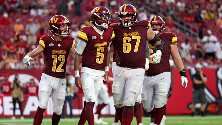 Sep 8, 2024; Tampa, Florida, USA; Washington Commanders quarterback Jayden Daniels (5) celebrates after scoring a touchdown against the Tampa Bay Buccaneers in the fourth quarter at Raymond James Stadium. Mandatory Credit: Nathan Ray Seebeck-Imagn Images