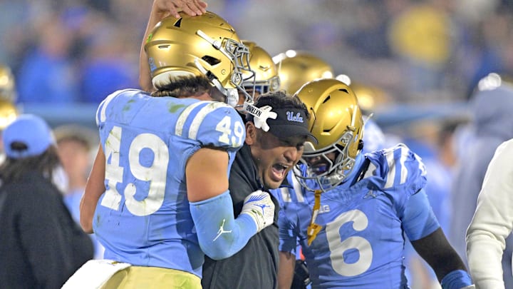 Former UCLA Bruins defensive coordinator Ikaika Malloe, center, celebrates with linebacker Carson Schwesinger (49) defensive back Jaylin Davies (6) after an interception in the second half against the Iowa Hawkeyes at the Rose Bowl. Former UCLA Bruins defensive coordinator Ikaika Malloe, center, celebrates with linebacker Carson Schwesinger (49) defensive back Jaylin Davies (6) after an interception in the second half against the Iowa Hawkeyes at the Rose Bowl.