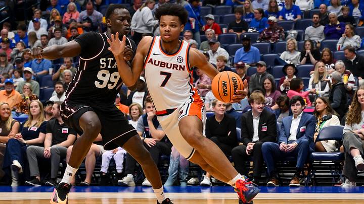 Mar 11, 2026; Nashville, TN, USA; Auburn Tigers guard Keyshawn Hall (7) drives to the basket past Mississippi State Bulldogs forward Achor Achor (99) during the first half at Bridgestone Arena. Mandatory Credit: Steve Roberts-Imagn Images Mar 11, 2026; Nashville, TN, USA; Auburn Tigers guard Keyshawn Hall (7) drives to the basket past Mississippi State Bulldogs forward Achor Achor (99) during the first half at Bridgestone Arena. Mandatory Credit: Steve Roberts-Imagn Images