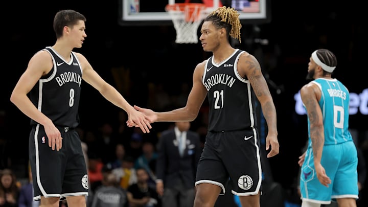Dec 1, 2025; Brooklyn, New York, USA; Brooklyn Nets guard Egor Demin (8) high fives forward Noah Clowney (21) in front of Charlotte Hornets forward Miles Bridges (0) during the third quarter at Barclays Center. Mandatory Credit: Brad Penner-Imagn Images