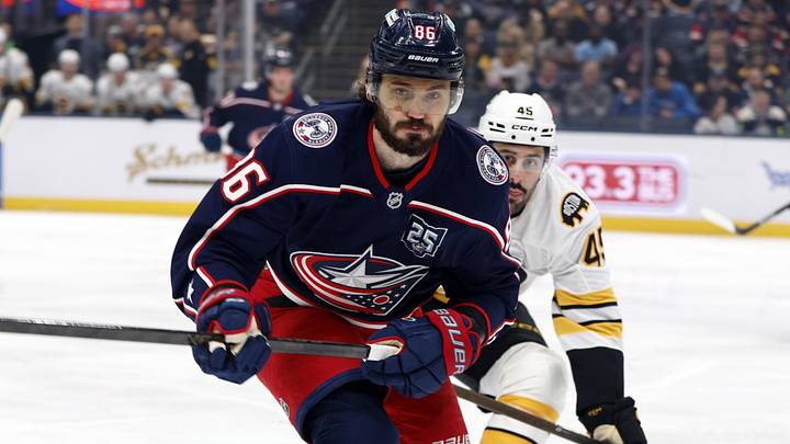 Apr 12, 2026; Columbus, Ohio, USA; Columbus Blue Jackets right wing Kirill Marchenko (86) and Boston Bruins defenseman Jonathan Aspirot (45) skate after a loose puck during the first period at Nationwide Arena. Mandatory Credit: Russell LaBounty-Imagn Images