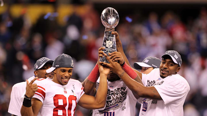 New York Giants wide receiver Victor Cruz (80) and wide receiver Hakeem Nicks (right) hoist the Vince Lombardi Trophy after Super Bowl XLVI against the New England Patriots at Lucas Oil Stadium.   