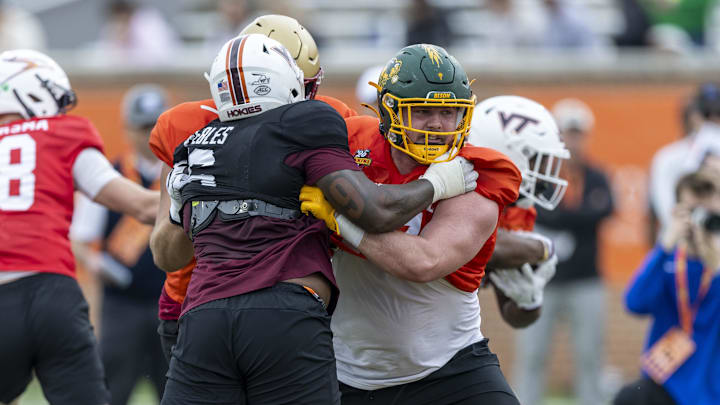North Dakota State lineman Grey Zabel (in orange) blocks at the Senior Bowl.