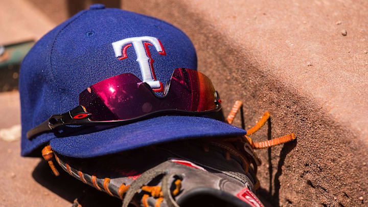 Jun 13, 2015; Arlington, TX, USA; A view a Texas Rangers baseball hat and glove during the game between the Texas Rangers and the Minnesota Twins at Globe Life Park in Arlington. The Rangers defeated the Twins 11-7. Jun 13, 2015; Arlington, TX, USA; A view a Texas Rangers baseball hat and glove during the game between the Texas Rangers and the Minnesota Twins at Globe Life Park in Arlington. The Rangers defeated the Twins 11-7.