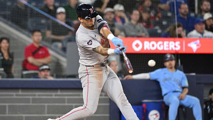 Sep 24, 2024; Toronto, Ontario, CAN;  Boston Red Sox second baseman Vaughn Grissom (5) hits an RBI single against the Toronto Blue Jays in the tenth inning at Rogers Centre. Mandatory Credit: Dan Hamilton-Imagn Images