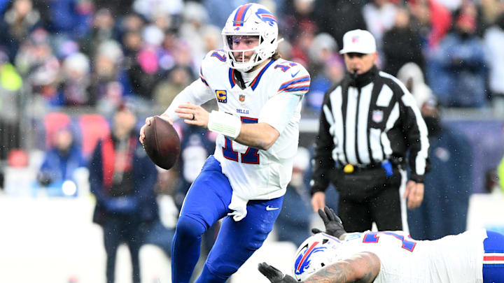 Buffalo Bills quarterback Josh Allen (17) runs against the New England Patriots during the second half at Gillette Stadium.