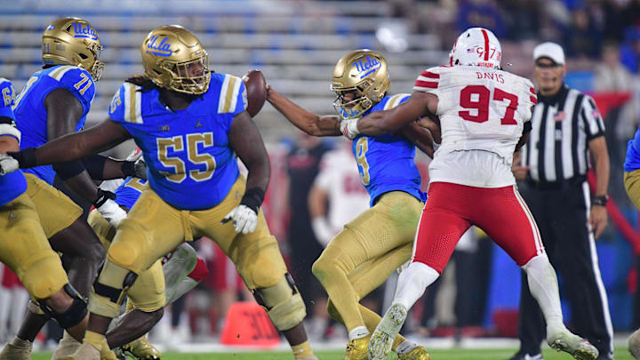 Nov 8, 2025; Pasadena, California, USA; UCLA Bruins quarterback Nico Iamaleava (9) is sacked by Nebraska Cornhuskers defensive lineman Keona Davis (97) during the second half at the Rose Bowl. Mandatory Credit: Gary A. Vasquez-Imagn Images