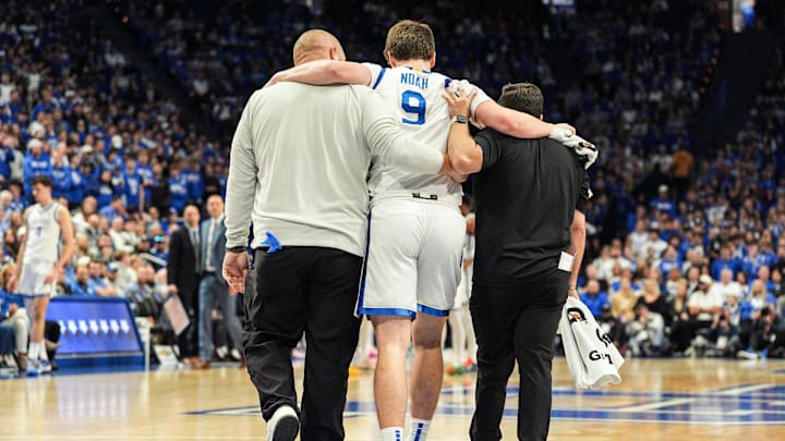 Kentucky Wildcats forward Trent Noah (9) gets help to the bench after getting injured while going for a loose ball in the first half at Rupp Arena in Lexington, Kentucky Nov. 4, 2025. Noah would get injured on the play and go to the bench.