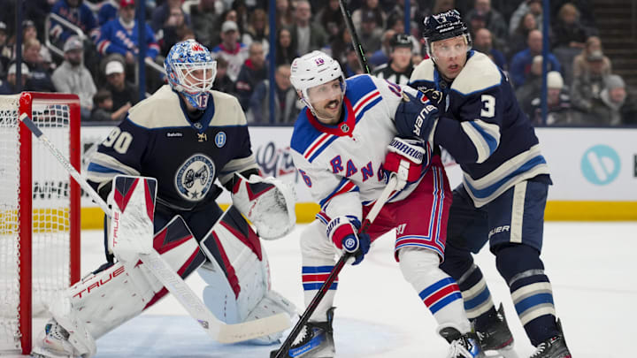 Feb 8, 2025; Columbus, Ohio, USA; Columbus Blue Jackets goaltender Elvis Merzlikins (90) defends the net as New York Rangers center Vincent Trocheck (16) skates against Columbus Blue Jackets defenseman Jack Johnson (3) in the first period at Nationwide Arena. Mandatory Credit: Aaron Doster-Imagn Images