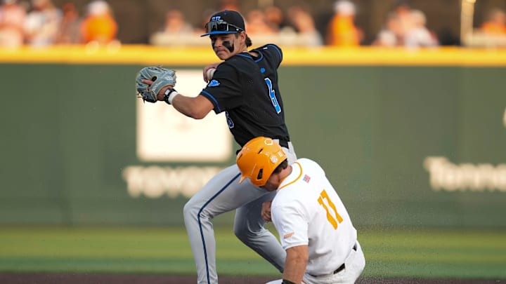 Kentucky infielder Tyler Bell (6) throws the ball to first base after getting Tennessee infielder Andrew Fischer (11) out at second base during a NCAA baseball game between Tennessee and Kentucky at Lindsey Nelson Stadium in Knoxville, Tenn., on April 18, 2025.