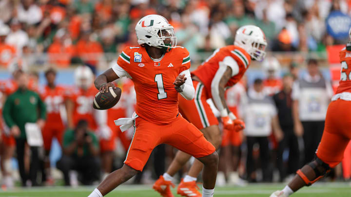 Dec 28, 2024; Orlando, FL, USA; Miami Hurricanes quarterback Cam Ward (1) drops back to pass against the Iowa State Cyclones in the first quarter during the Pop Tarts bowl at Camping World Stadium. Mandatory Credit: Nathan Ray Seebeck-Imagn Images