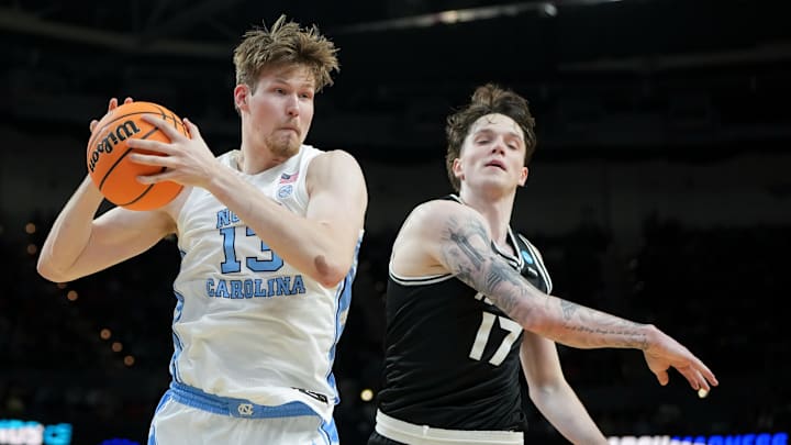 Mar 19, 2026; Greenville, SC, USA; North Carolina Tar Heels center Henri Veesaar (13) rebounds the ball against VCU Rams forward Lazar Djokovic (17) in the first half of a first round game of the men's 2026 NCAA Tournament at Bon Secours Wellness Arena. Mandatory Credit: Bob Donnan-Imagn Images