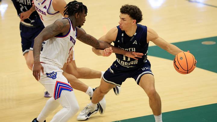 North Florida Ospreys guard Kamrin Oriol (11) dribbles against West Georgia Wolves forward Shelton Williams-Dryden (4) during the second half of the ASUN Men’s Basketball Championship first round matchup at Swisher Gymnasium, Wednesday, March 4, 2026, in Jacksonville, Fla. The West Georgia Wolves defeated the North Florida Ospreys 93-85. [Corey Perrine/Florida Times-Union]