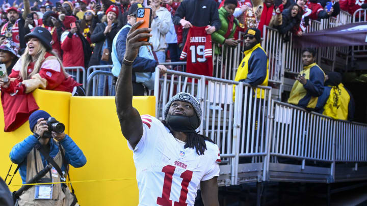 Dec 31, 2023; Landover, Maryland, USA; San Francisco 49ers wide receiver Brandon Aiyuk (11) celebrates with fans after defeating the Washington Commanders at FedExField. Mandatory Credit: Brad Mills-USA TODAY Sports