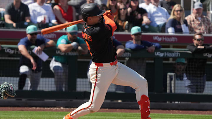 Mar 15, 2025; Scottsdale, Arizona, USA; San Francisco Giants shortstop Willy Adames (2) hits a single against the Seattle Mariners in the third inning at Scottsdale Stadium. Mandatory Credit: Rick Scuteri-Imagn Images
