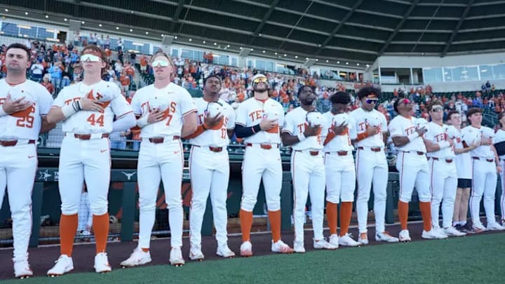 The Texas Longhorns line up for the national anthem prior to the first pitch. The Texas Longhorns line up for the national anthem prior to the first pitch.