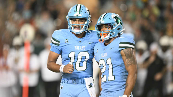 Tulane Green Wave players Darian Mensah (10) and Makhi Hughes (21) talk to each other.