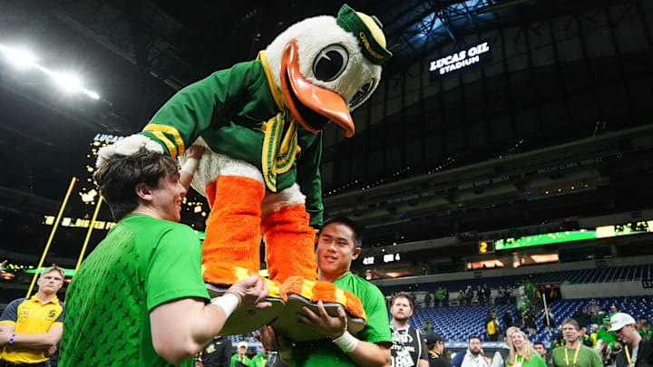 The Oregon Duck is lifted by cheerleaders after Oregon's win over Penn State in the 2024 Big Ten Championship Game at Lucas Oil Stadium. 
