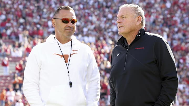 Nov 16, 2024; Fayetteville, Arkansas, USA; Texas Longhorns head coach Steve Sarkisian and Arkansas Razorbacks head coach Sam Pittman interact prior to the game at Donald W. Reynolds Razorback Stadium. Mandatory Credit: Nelson Chenault-Imagn Images