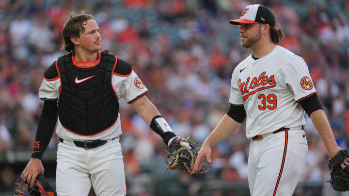 Jun 27, 2024; Baltimore, Maryland, USA; Baltimore Orioles pitcher Corbin Burnes (39) is greeted by catcher Adley Rutschman (35) at the end of the second inning against the Texas Rangers at Oriole Park at Camden Yards. Jun 27, 2024; Baltimore, Maryland, USA; Baltimore Orioles pitcher Corbin Burnes (39) is greeted by catcher Adley Rutschman (35) at the end of the second inning against the Texas Rangers at Oriole Park at Camden Yards.