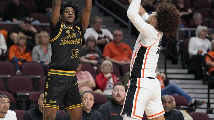 March 8, 2026; Las Vegas, NV, USA; San Francisco Dons guard Legend Smiley (13) shoots the basketball against Oregon State Beavers forward Isaiah Sy (13) during the first half at Orleans Arena. Mandatory Credit: Kyle Terada-Imagn Images