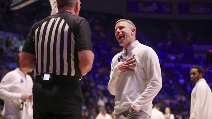 Feb 18, 2026; Morgantown, West Virginia, USA; West Virginia Mountaineers head coach Ross Hodge argues as he walks into the locker room for halftime against the Utah Utes at Hope Coliseum. Mandatory Credit: Ben Queen-Imagn Images