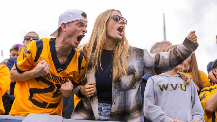 Nov 8, 2025; Morgantown, West Virginia, USA; West Virginia Mountaineers fans cheer during the fourth quarter against the Colorado Buffaloes at Milan Puskar Stadium. Mandatory Credit: Ben Queen-Imagn Images Nov 8, 2025; Morgantown, West Virginia, USA; West Virginia Mountaineers fans cheer during the fourth quarter against the Colorado Buffaloes at Milan Puskar Stadium. Mandatory Credit: Ben Queen-Imagn Images