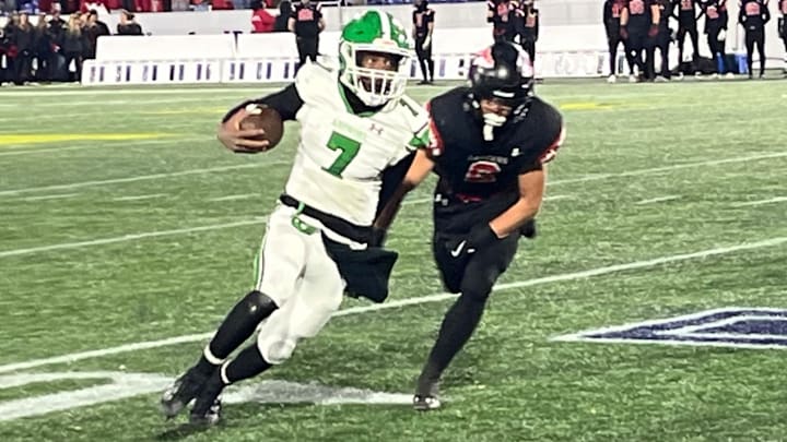 Arundel quarterback Amir Lowery (7) is chased by Linganore’s Ben Butler during Saturday’s Maryland Class 3A state championship game. Arundel won its first title since 1975 with a 35-7 rout of the previously undefeated Lancers at Navy-Marine Corps Memorial Stadium.