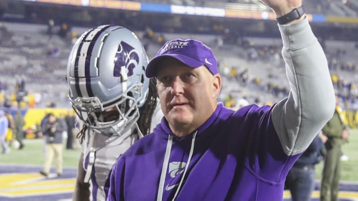 Oct 19, 2024; Morgantown, West Virginia, USA; Kansas State Wildcats head coach Chris Klieman celebrates with fans after defeating the West Virginia Mountaineers at Mountaineer Field at Milan Puskar Stadium. Mandatory Credit: Ben Queen-Imagn Images Oct 19, 2024; Morgantown, West Virginia, USA; Kansas State Wildcats head coach Chris Klieman celebrates with fans after defeating the West Virginia Mountaineers at Mountaineer Field at Milan Puskar Stadium. Mandatory Credit: Ben Queen-Imagn Images
