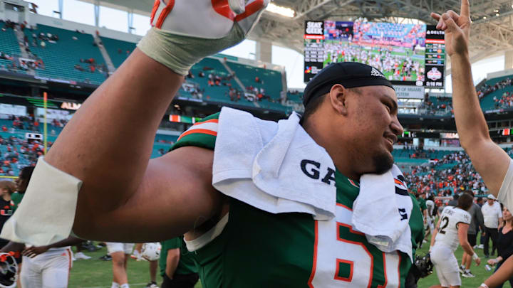 Nov 23, 2024; Miami Gardens, Florida, USA; Miami Hurricanes head coach Mario Cristobal celebrates with Miami Hurricanes offensive lineman Francis Mauigoa (61) and tight end Elijah Arroyo (8) after the game against the Wake Forest Demon Deacons at Hard Rock Stadium. Mandatory Credit: Sam Navarro-Imagn Images