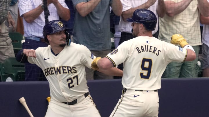 Milwaukee Brewers first baseman Jake Bauers (9) is congratulated by shortstop Willy Adames (27) after hitting a grand slam home run off of Texas Rangers pitcher Nathan Eovaldi during the third inning of their game Wednesday, June 26, 2024 at American Family Field in Milwaukee, Wisconsin.