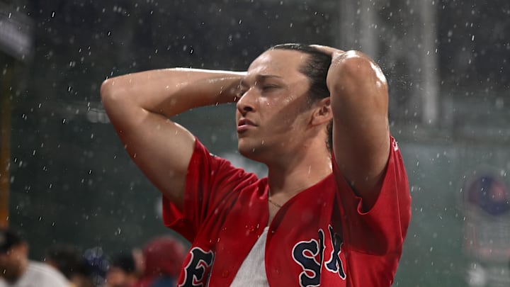 Jun 28, 2023; Boston, Massachusetts, USA; A Boston Red Sox fan reacts during a rain delay in a game