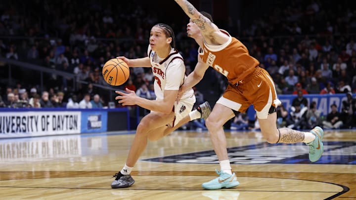 Mar 17, 2026; Dayton, OH, USA; NC State Wolfpack guard Matt Able (3) dribbles the ball defended by Texas Longhorns guard Chendall Weaver (2) in the first half during a first four game of the men's 2026 NCAA Tournament at University of Dayton Arena. Mandatory Credit: Rick Osentoski-Imagn Images Mar 17, 2026; Dayton, OH, USA; NC State Wolfpack guard Matt Able (3) dribbles the ball defended by Texas Longhorns guard Chendall Weaver (2) in the first half during a first four game of the men's 2026 NCAA Tournament at University of Dayton Arena. Mandatory Credit: Rick Osentoski-Imagn Images