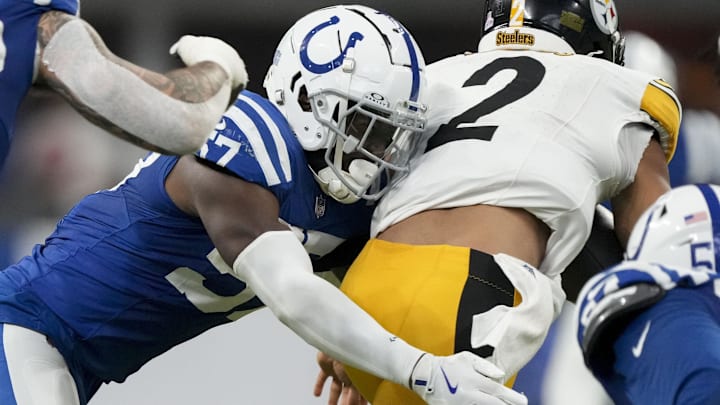 Sep 29, 2024; Indianapolis, Indiana, USA;  Indianapolis Colts linebacker Jaylon Carlies (57) wraps up Pittsburgh Steelers quarterback Justin Fields (2) on Sunday, Sept. 29, 2024, during a game against the Pittsburgh Steelers at Lucas Oil Stadium. Mandatory Credit: Christine Tannous-USA TODAY Network via Imagn Images